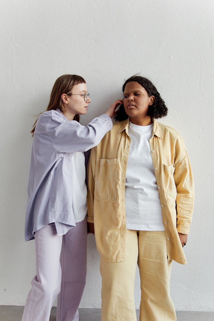 Photograph of a Girl Fixing Another Girl's Hair