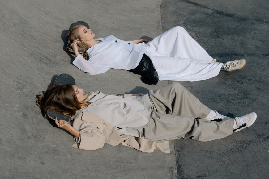 Women in Fashionable Outfit Sleeping on a Skate Ramp